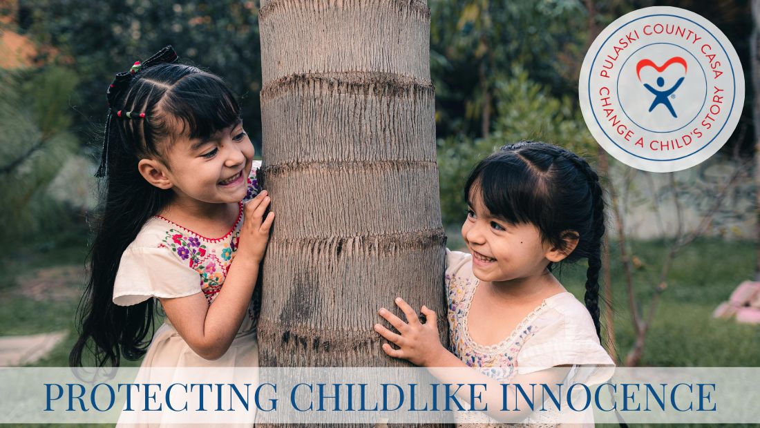 2 little girls standing on each side of a tree smiling at each other with the words protecting childlike innocence at the bottom.