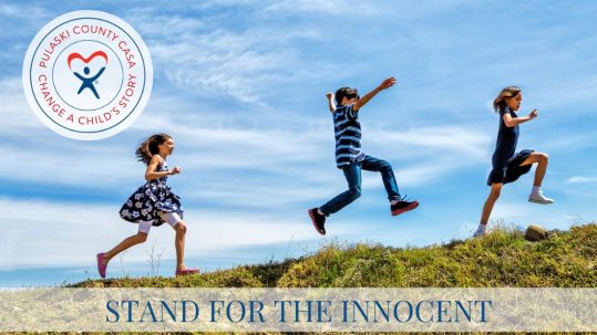 Three children marching and leaping up a hill on a bright sunny day with the text "Stand for the Innocent".
