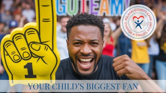 Image of a dad holding a giant #1 foam finger. People in the back are holding up letters that spell "Go Team". The image says "Your Child's Biggest Fan."
