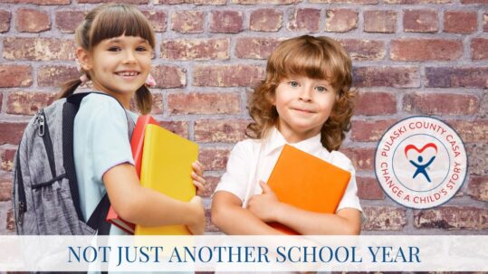 Picture of two children holding books and smiling in front of a brick wall, with the text "Not Just Another School Year"